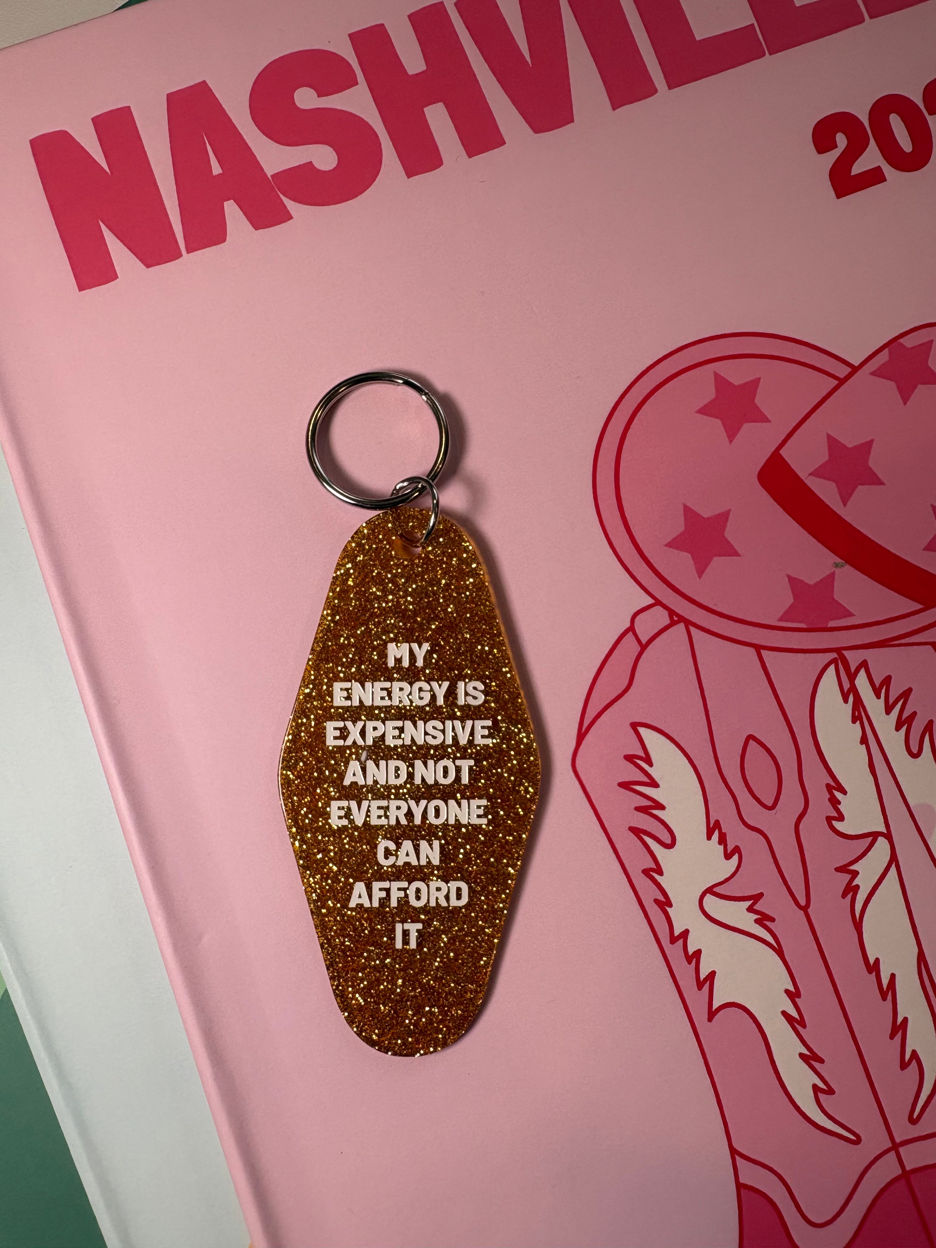 Keychain with "My Energy is Expensive and Not Everyone Can Afford It" text