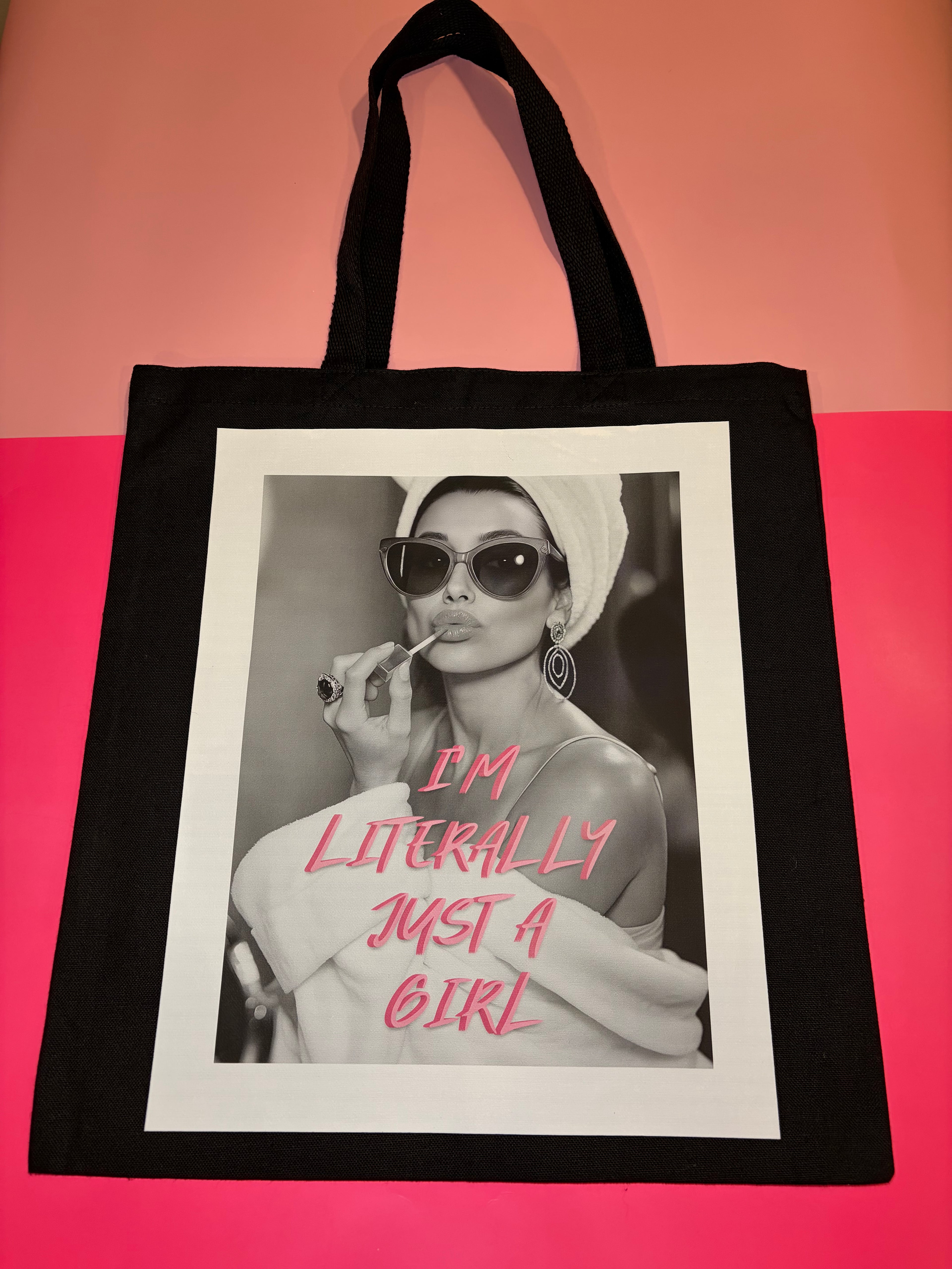 Black tote bag with a graphic of a woman and pink text 'I'm literally just a girl'