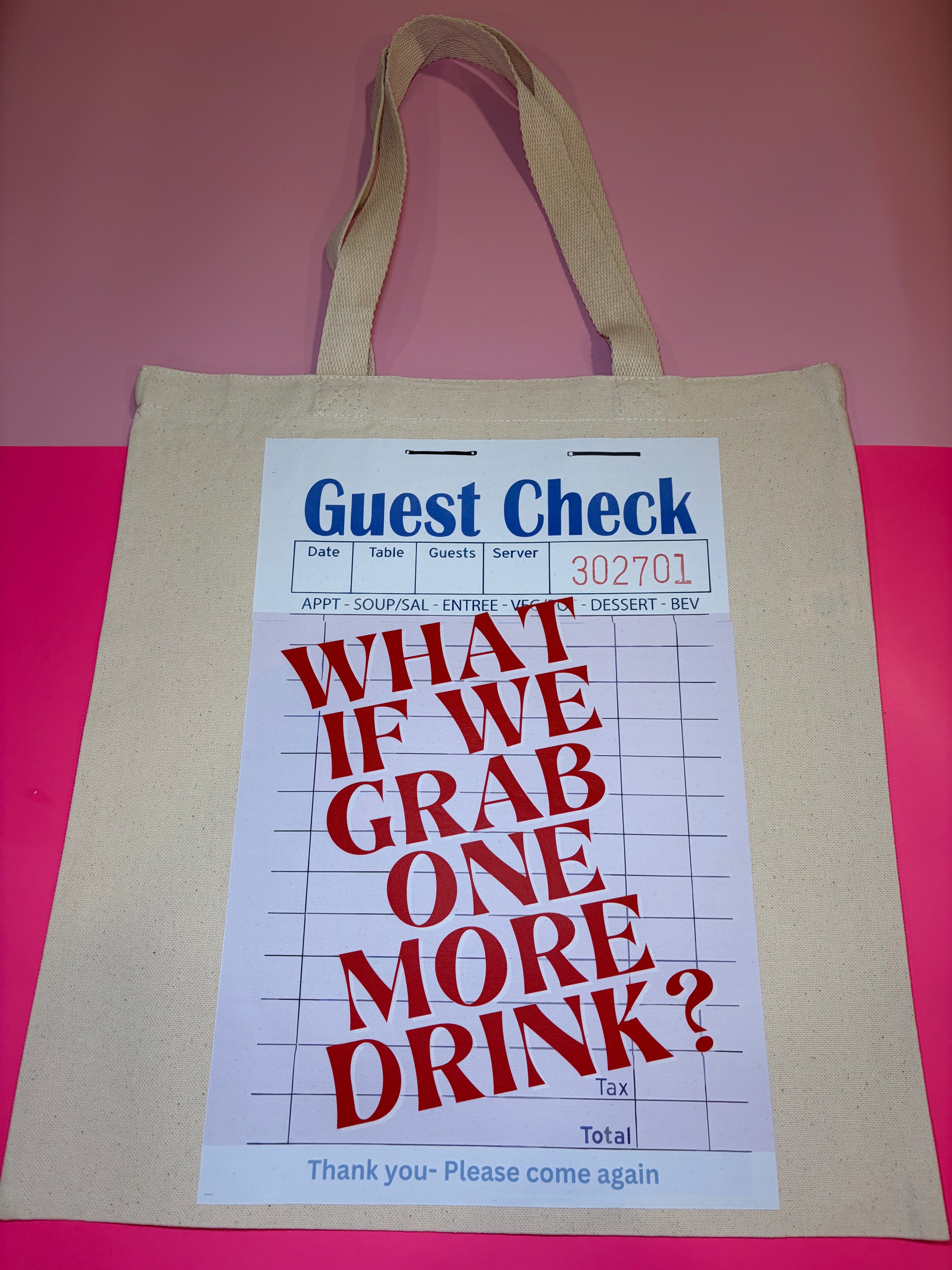 Beige tote bag with printed design resembling a restaurant check on a pink background