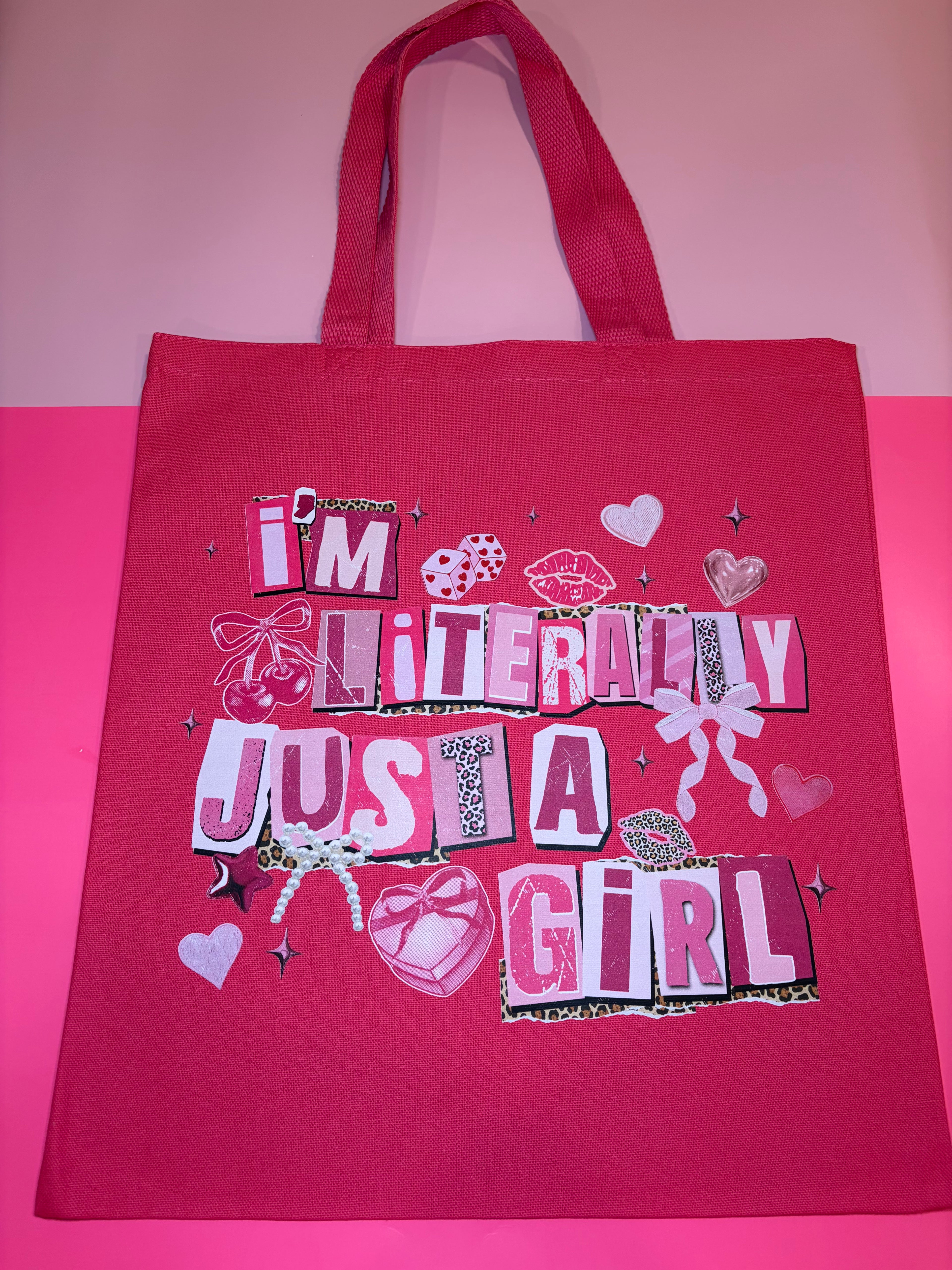 Hot pink tote bag with colorful text and graphics on a pink background