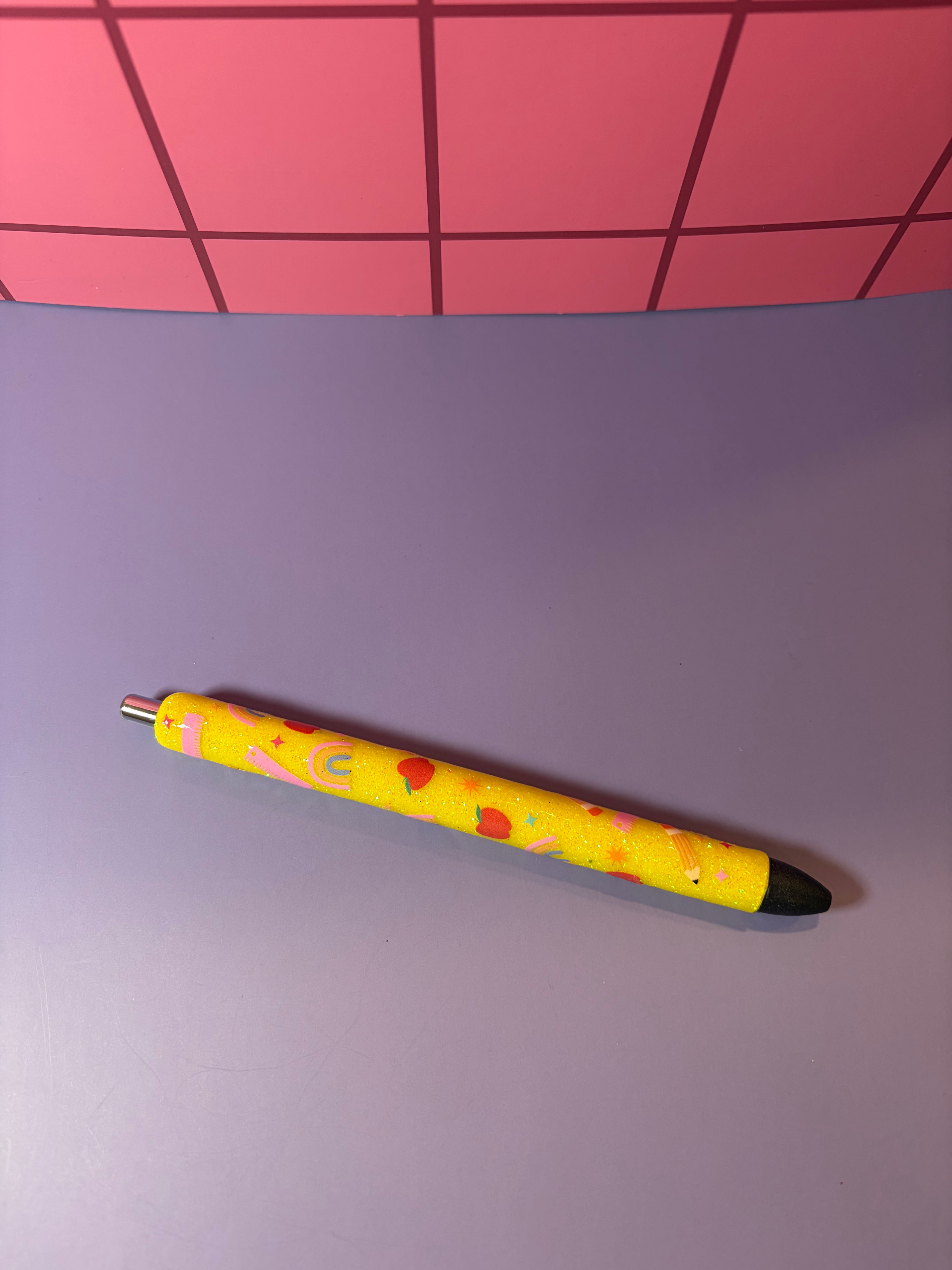 Yellow glitter pen with colorful school icons