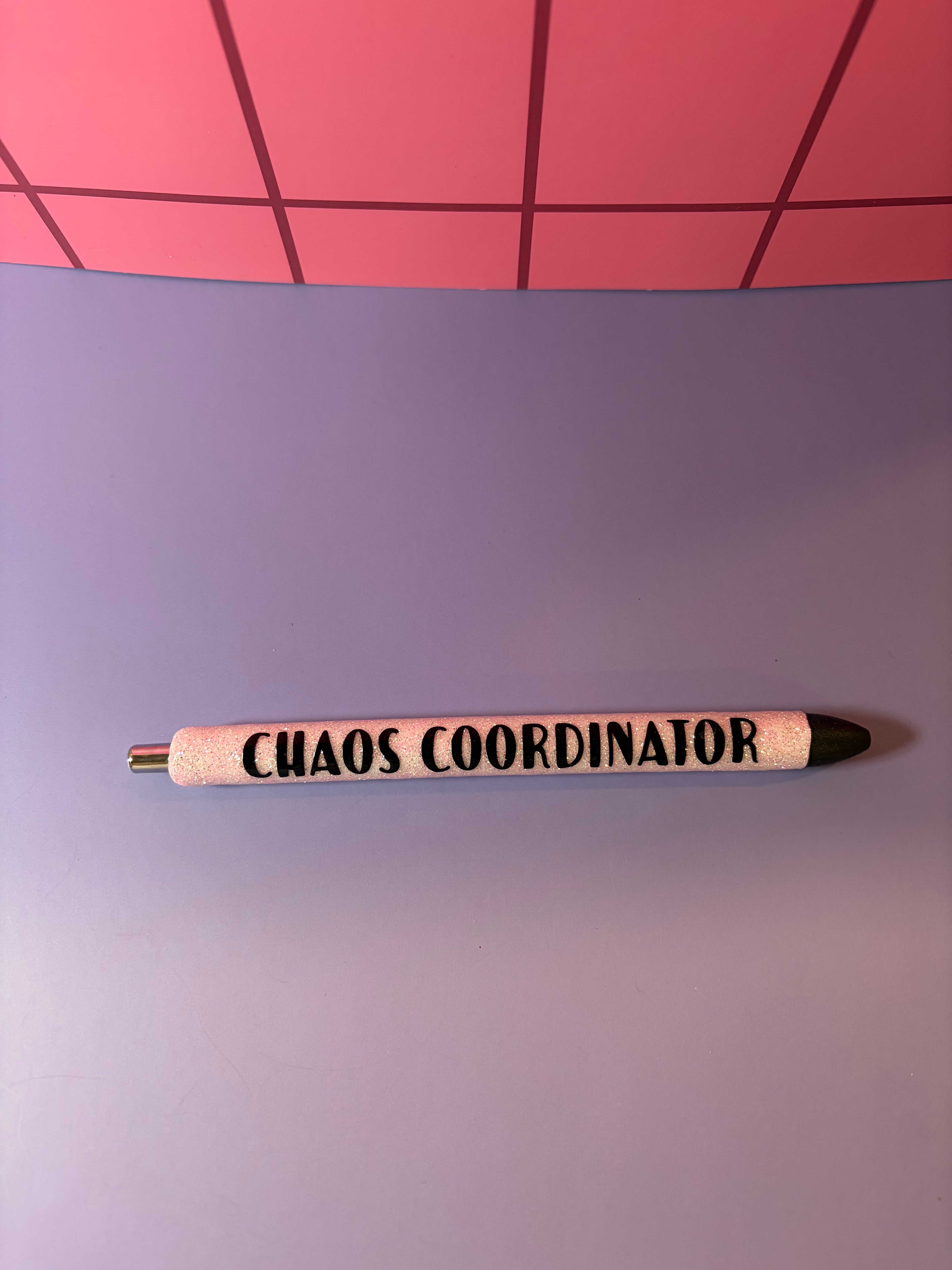White glitter pen with black 'CHAOS COORDINATOR' text 