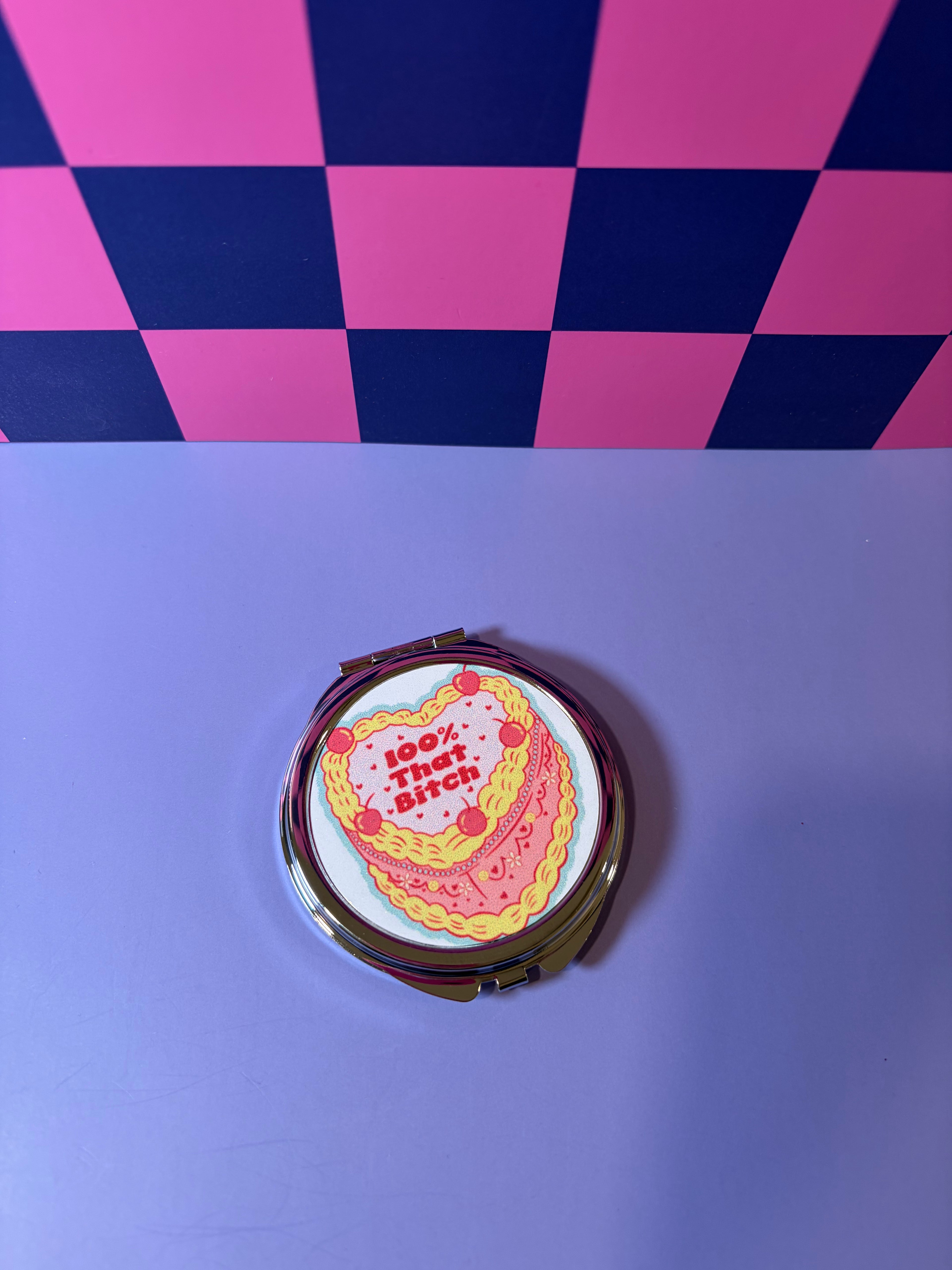 Compact mirror with "100% that Bitch" graphic