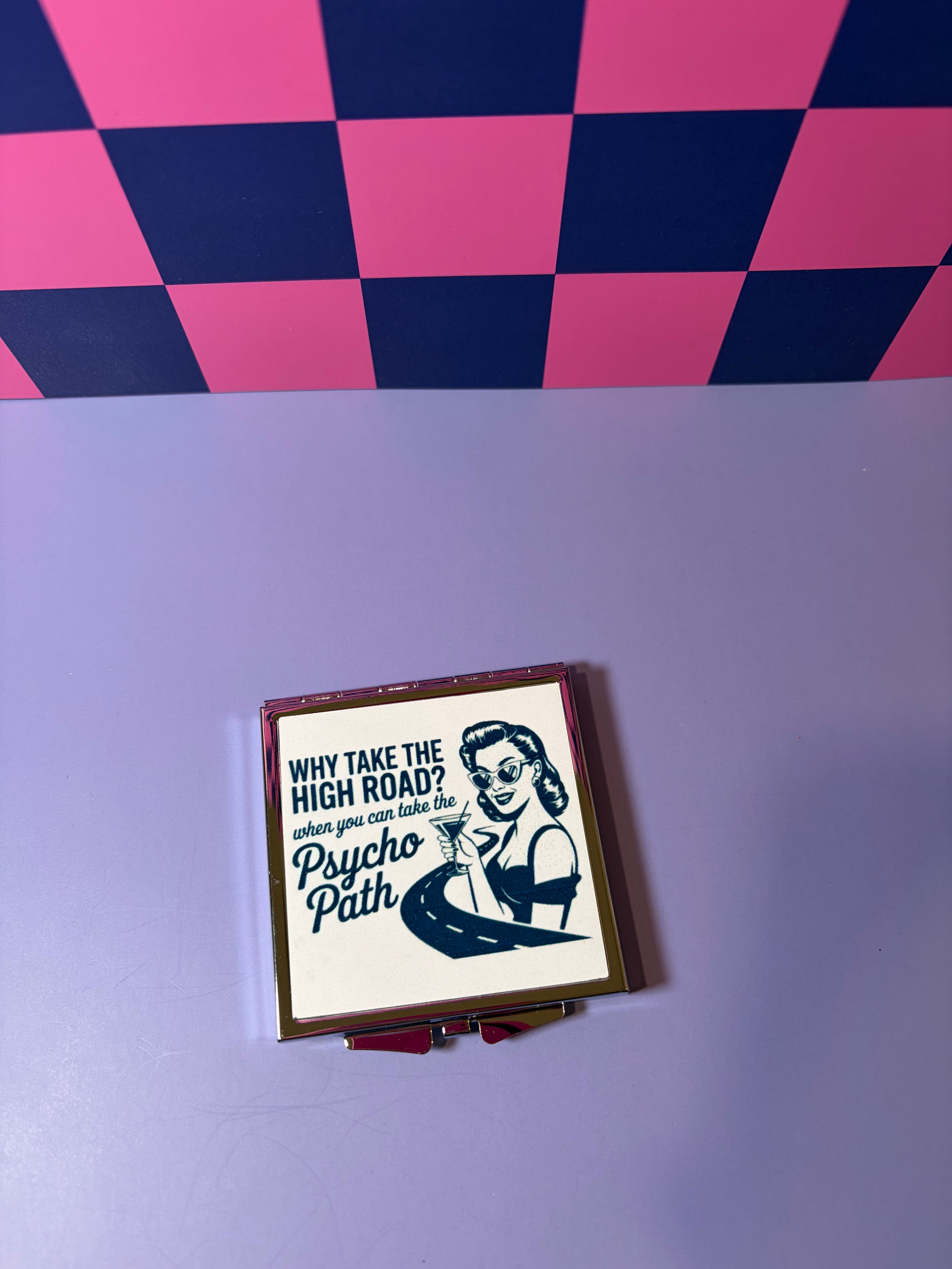 Compact mirror with "Why Take the High Road? When You Can Take the Psycho Path" graphic