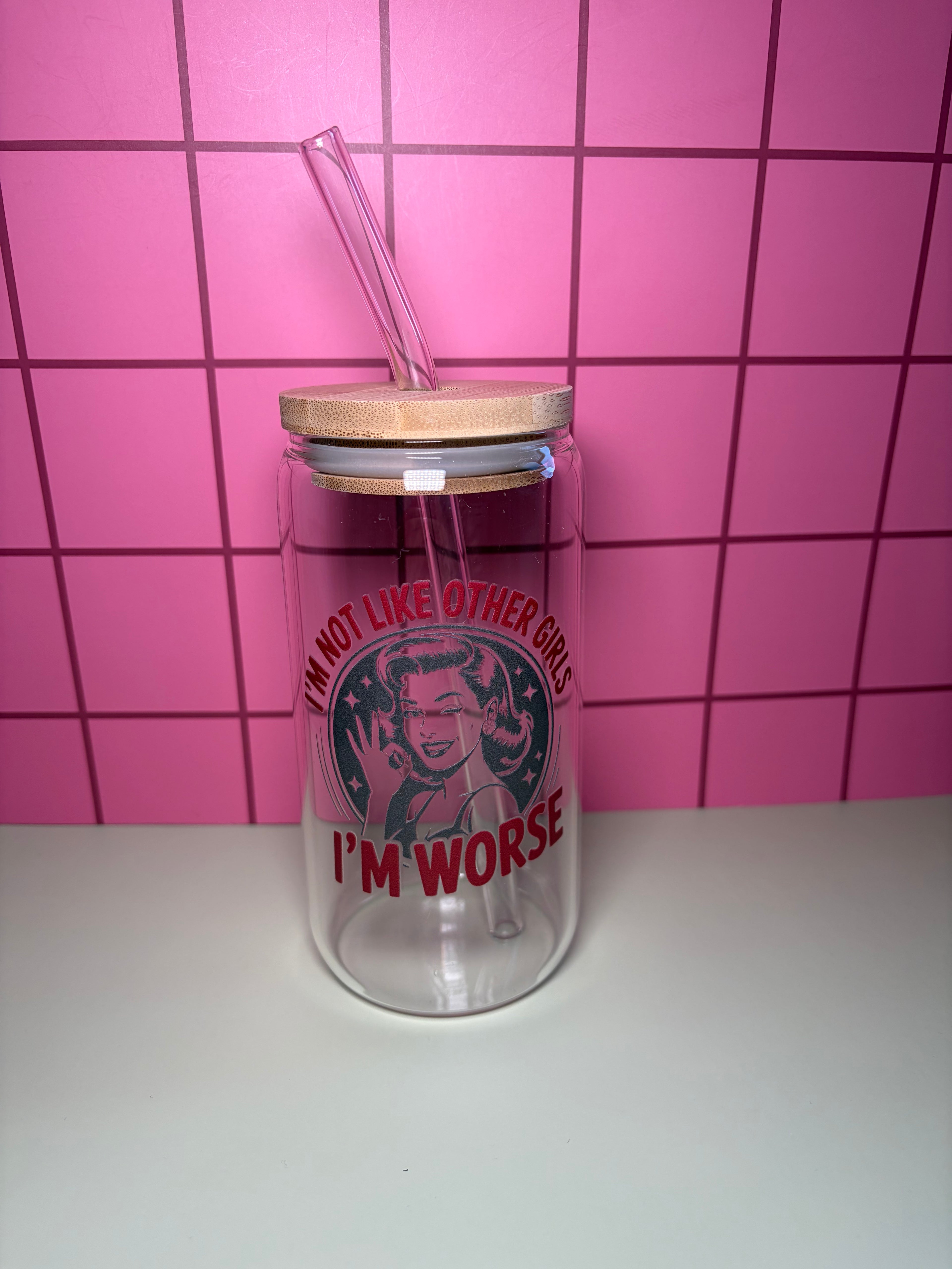 16 oz glass can with wooden lid and straw. Decal on the cup says I'm not like other girls, I'm worse with an image of a woman smiling. 