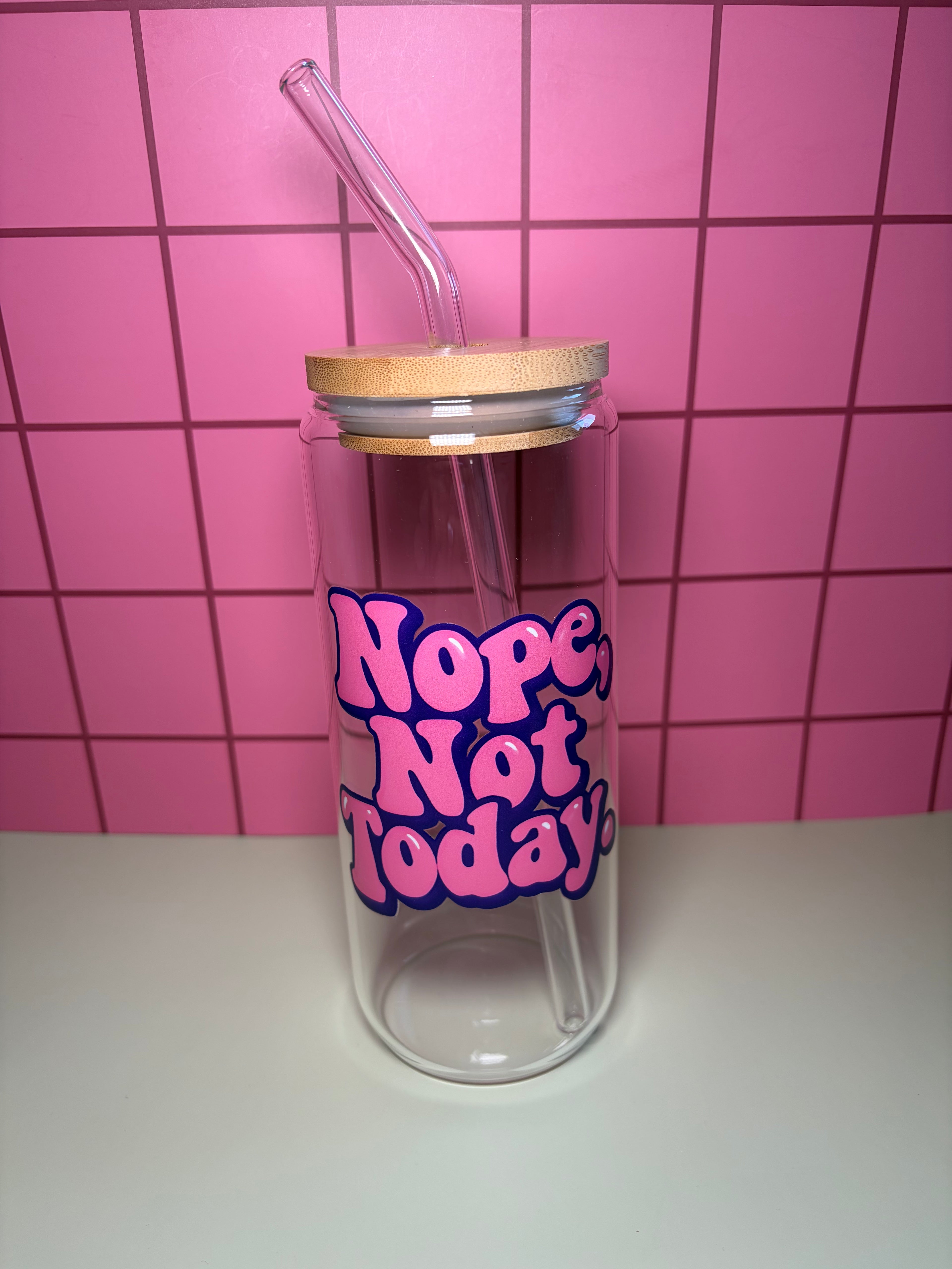 20 oz glass can with wooden lid and straw. The decal says Nope, not today in pink and purple bubble letters. 