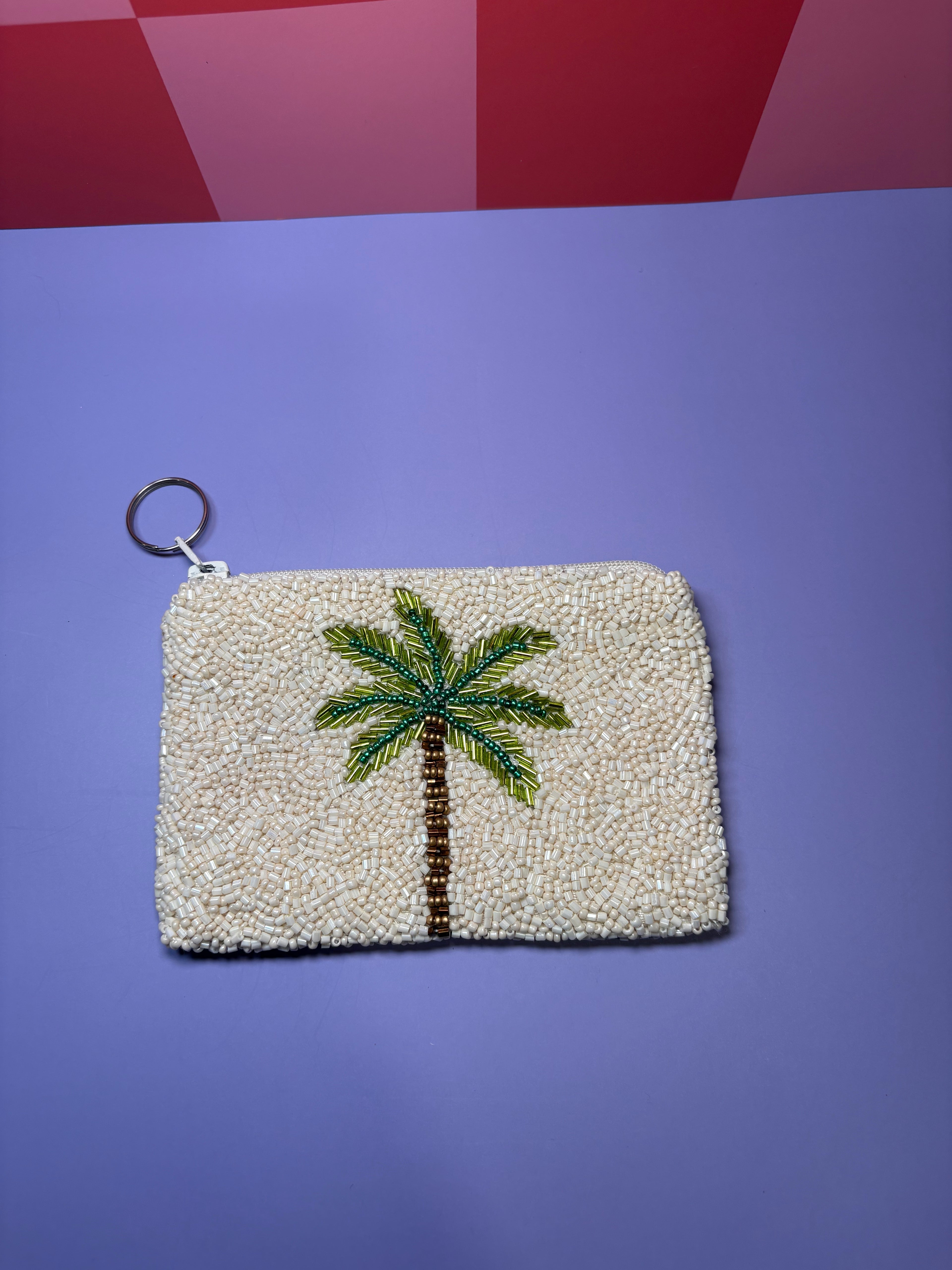 Palm tree design on beige beaded pouch