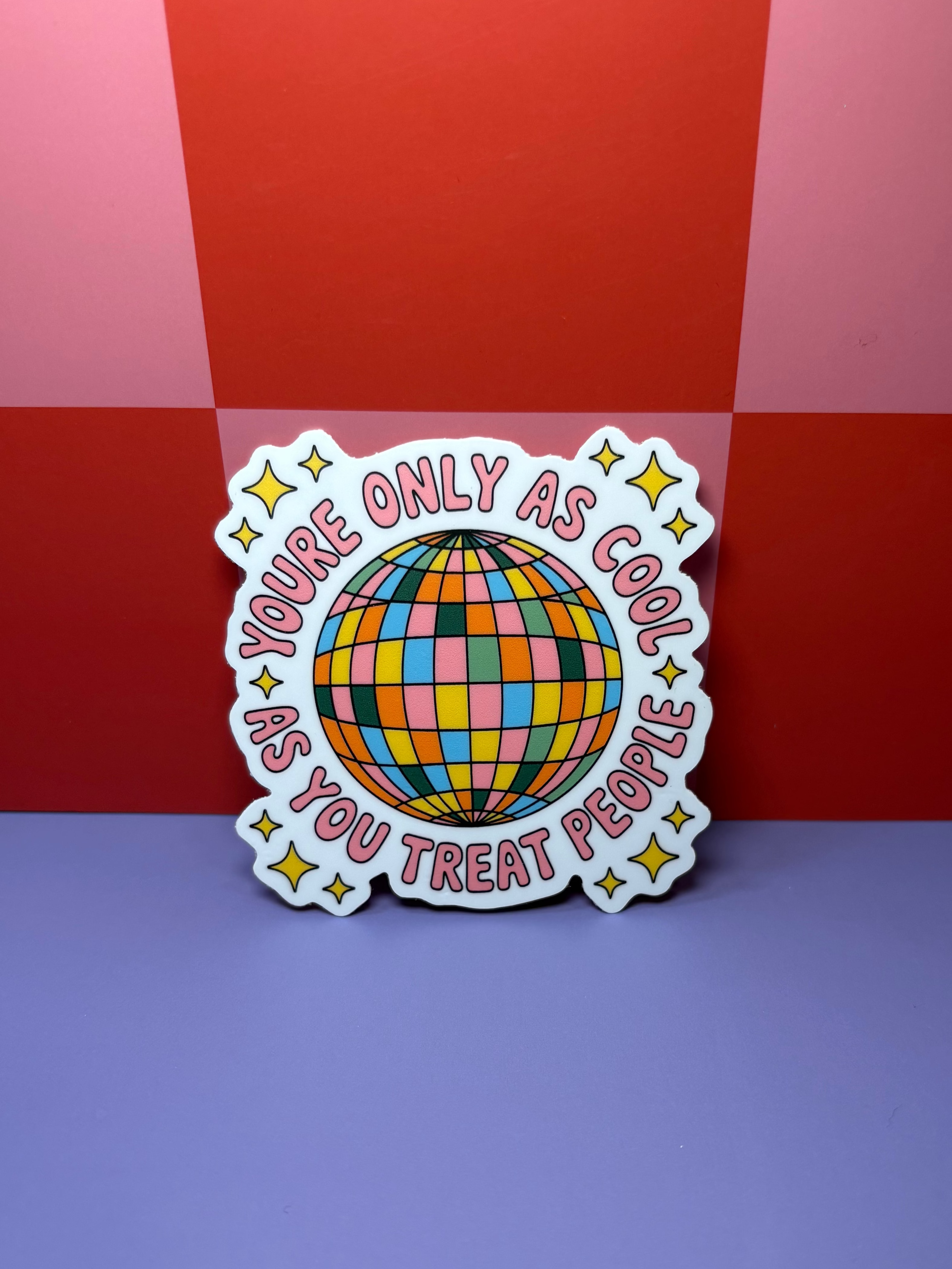 Colorful sticker with a rainbow disco ball design and pink "You're only as cool as you treat people"