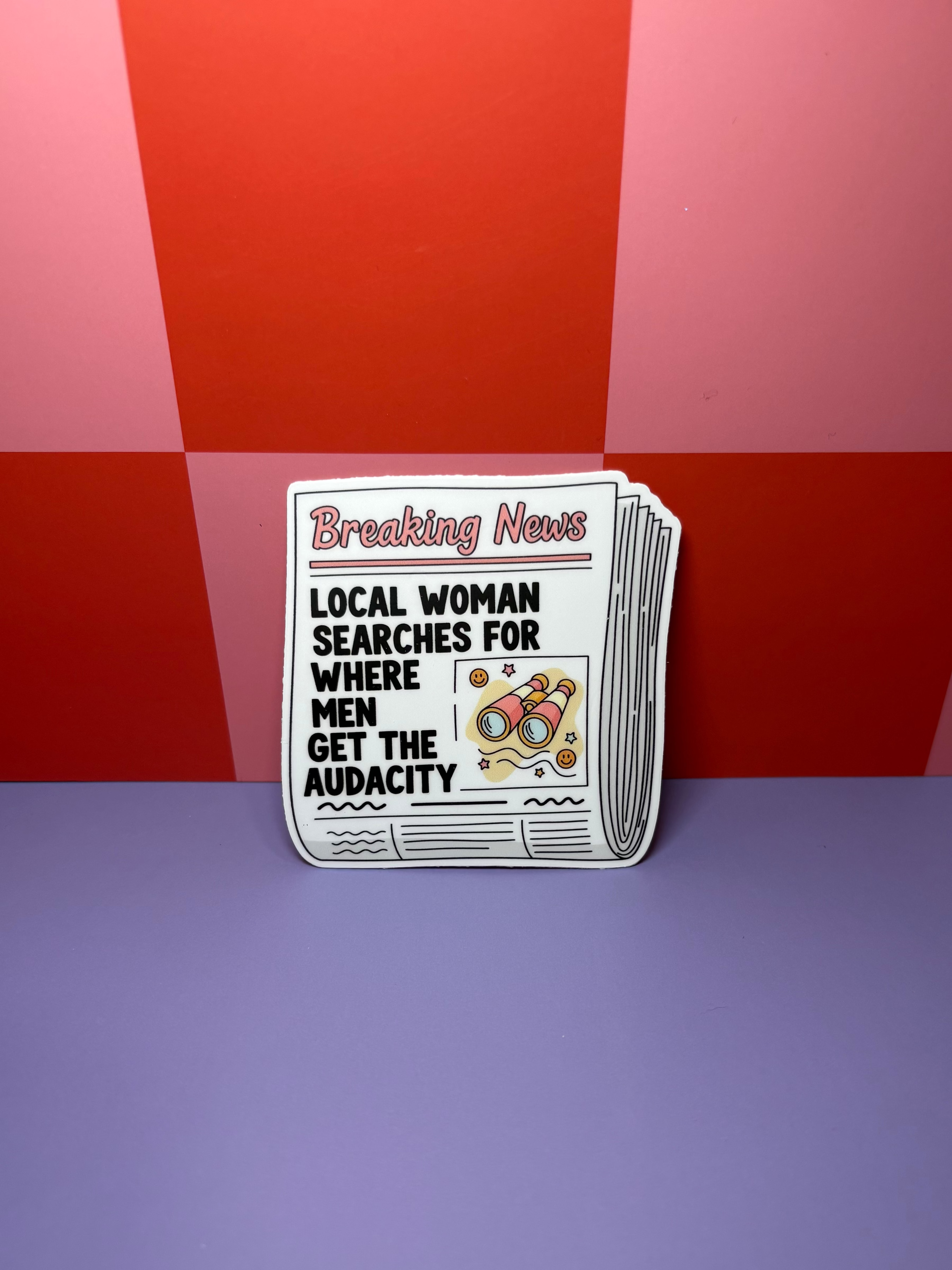 Newspaper sticker with headline "Local Woman Searches for Where Men Have the Audacity"