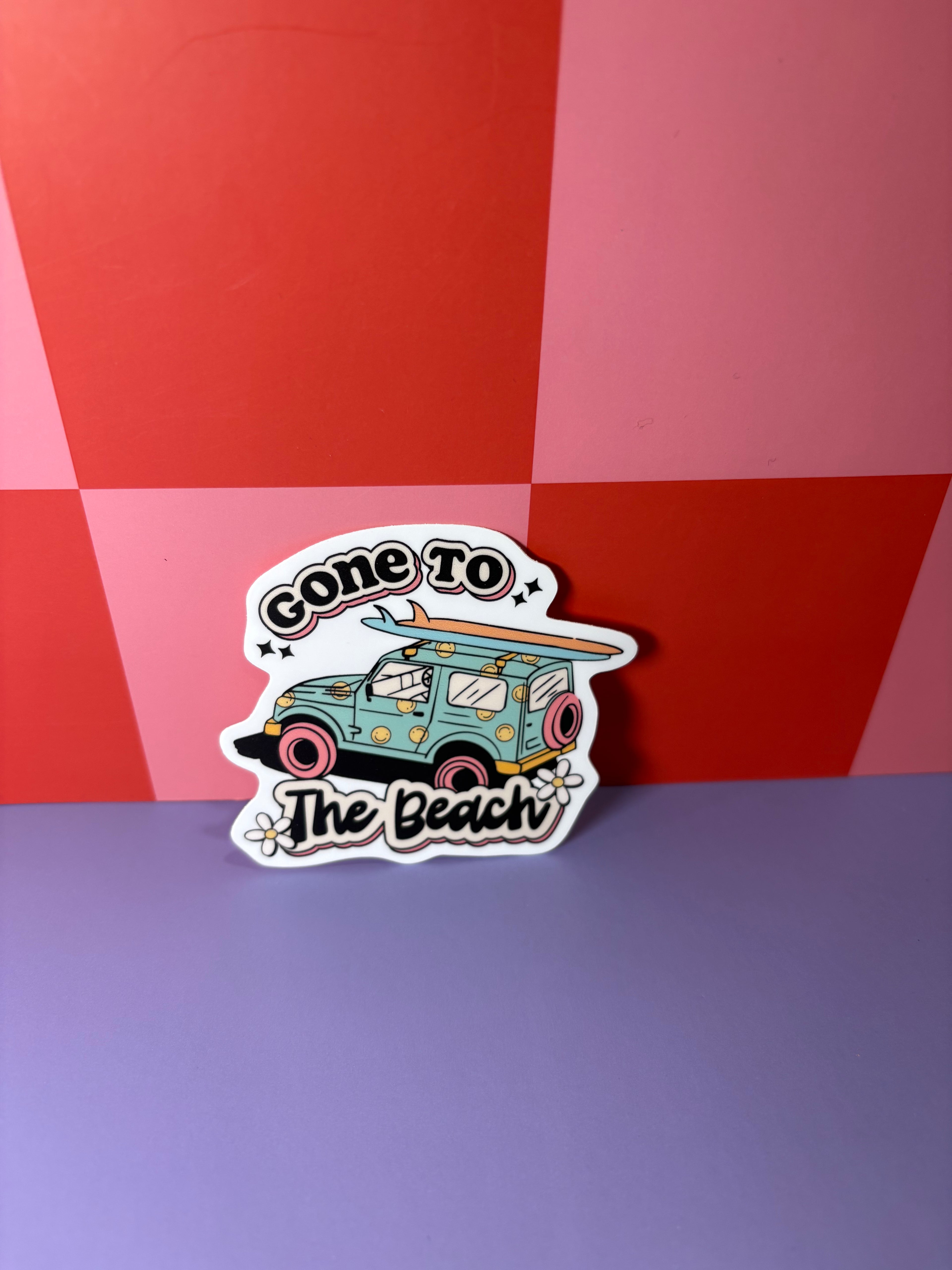 Gone to the Beach sticker with blue and pink car, flowers, and surfboards
