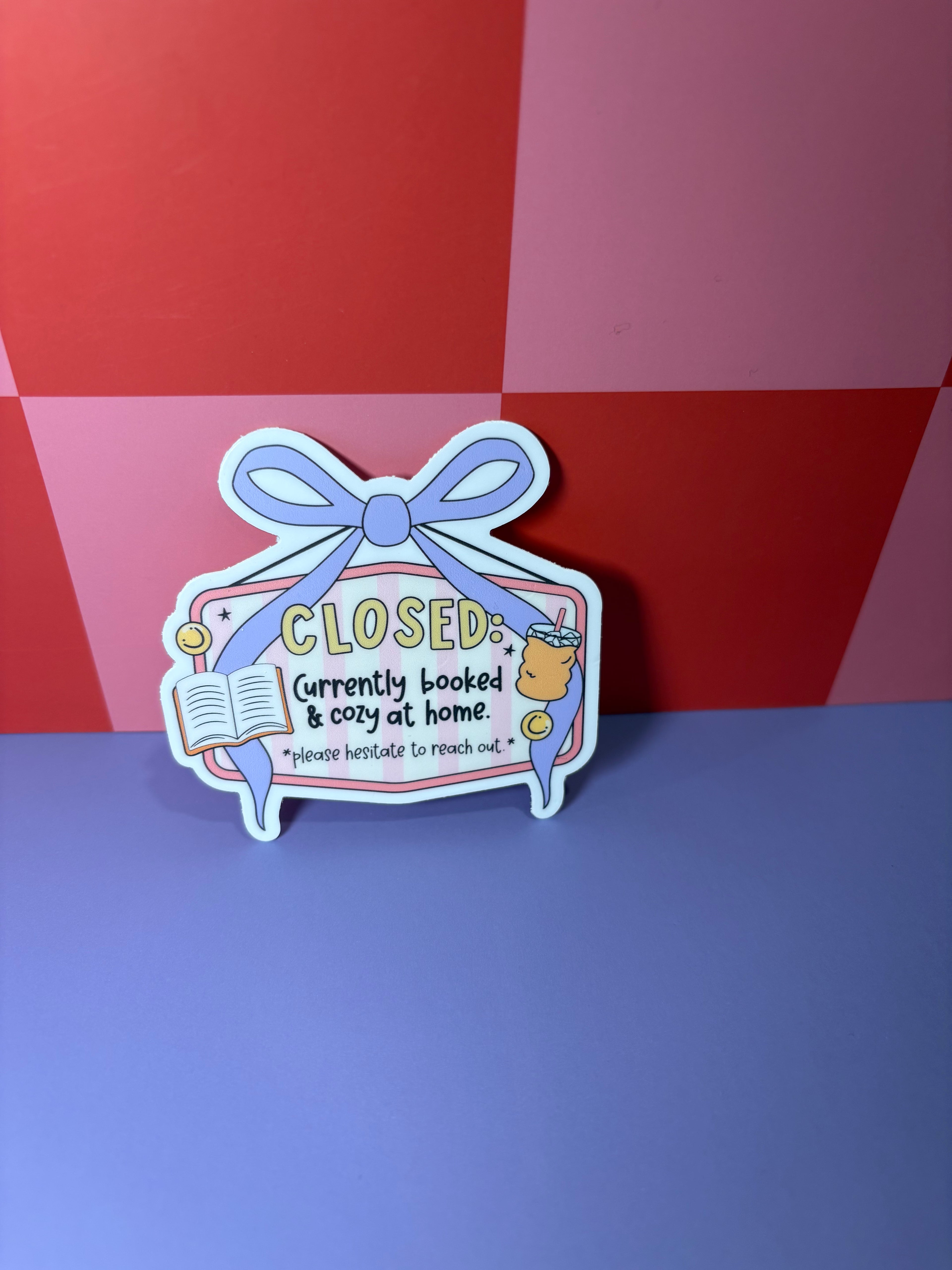 Closed sign sticker with "Closed: Currently booked and cozy at home. Please hesitate to reach out"