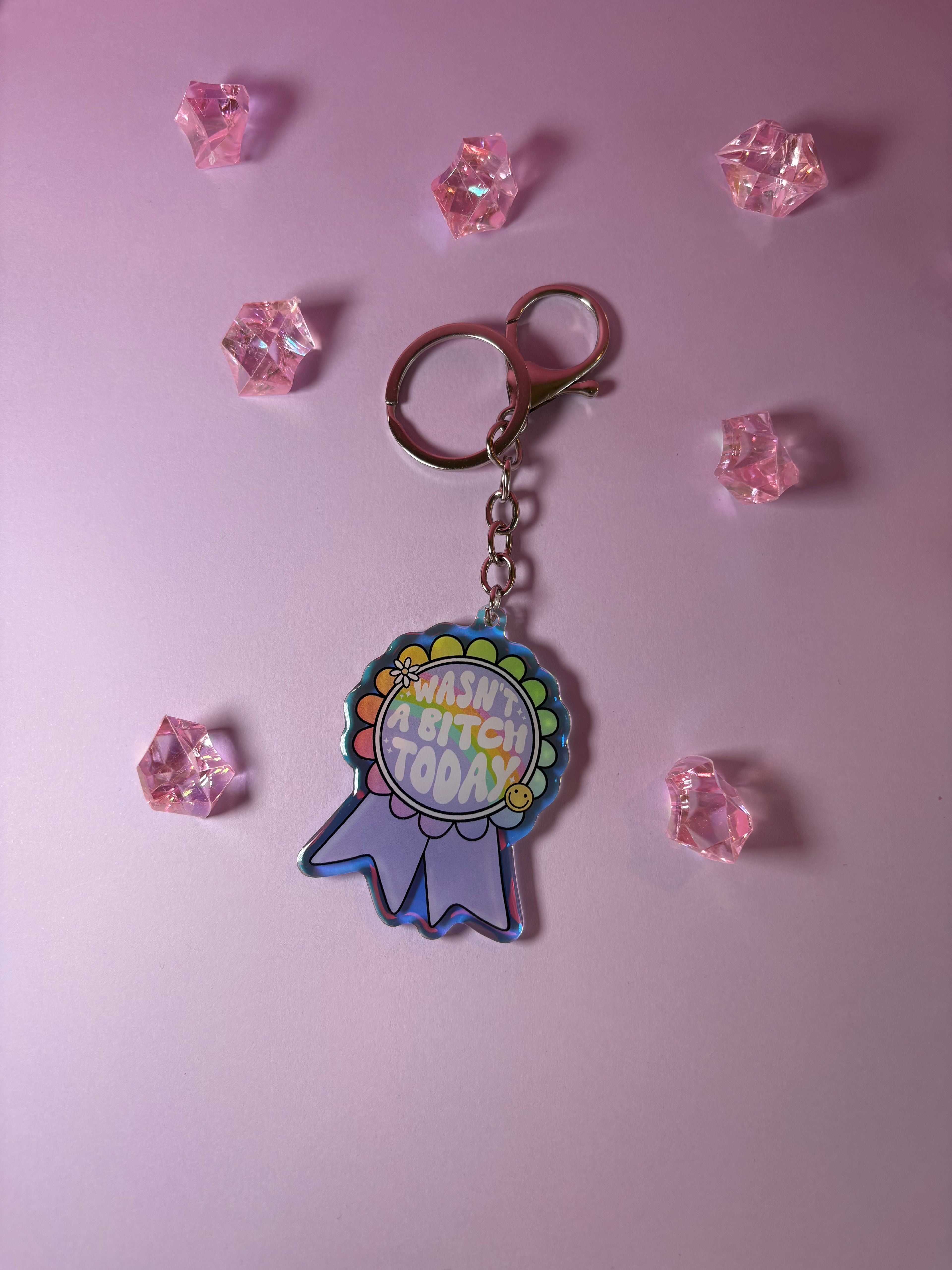 Keychain with colorful design on a medal with "wasn't a bitch today" text