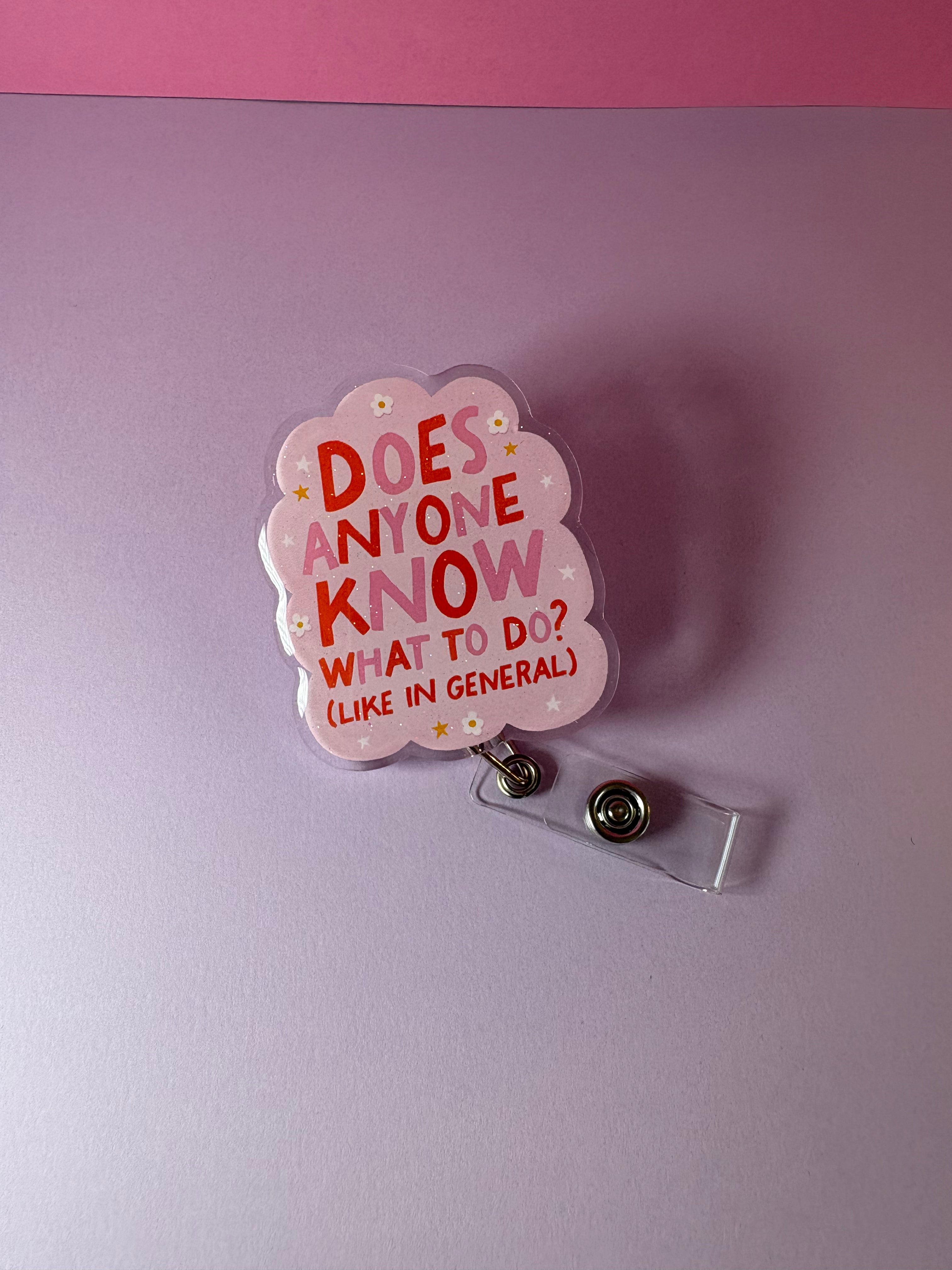 Flowery, cloud-shaped badge reel with "Does anyone know what to do? (like in general)"