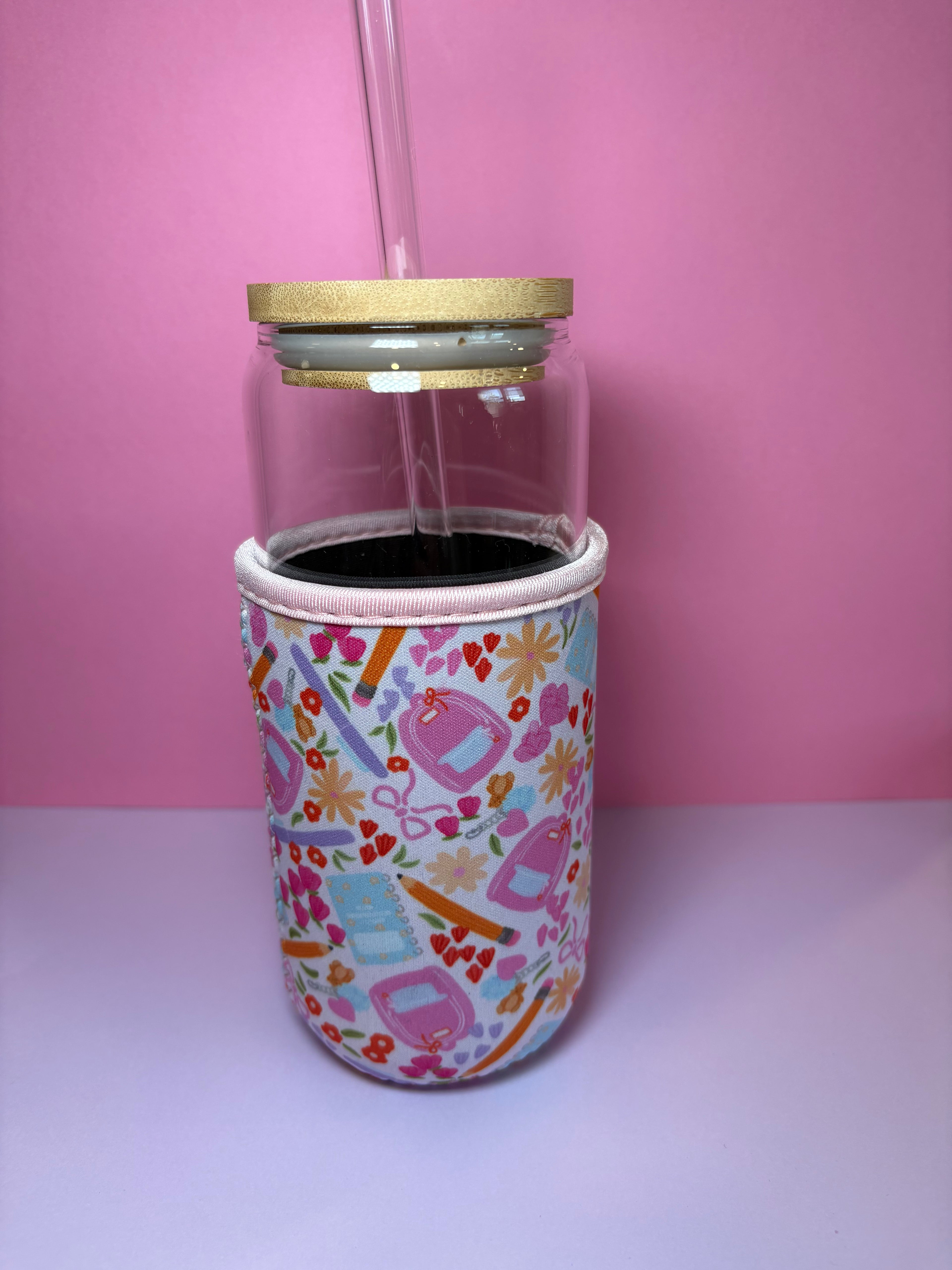 White cup koozie with colorful school icons