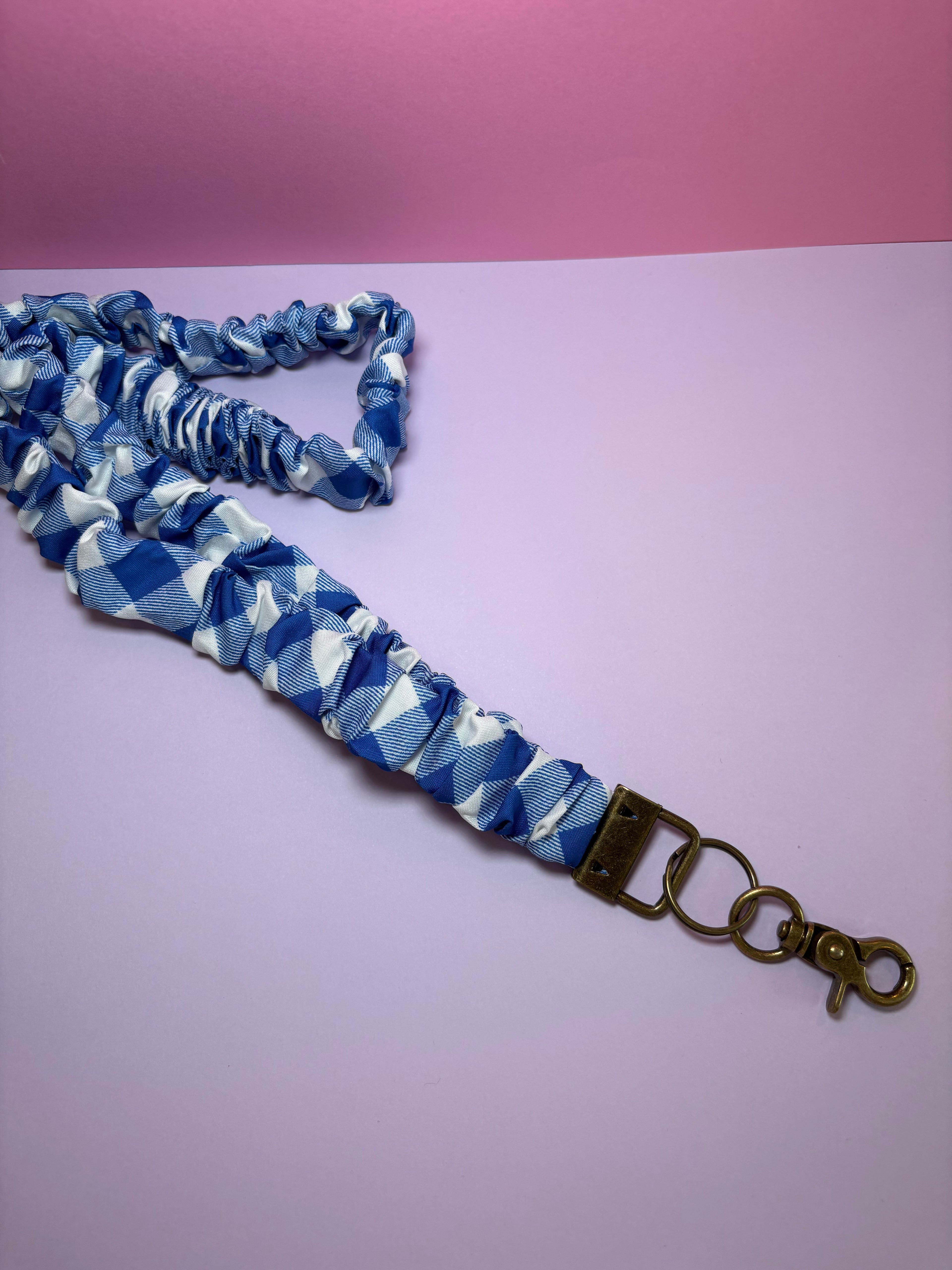 Blue and white gingham lanyard with a metal clasp