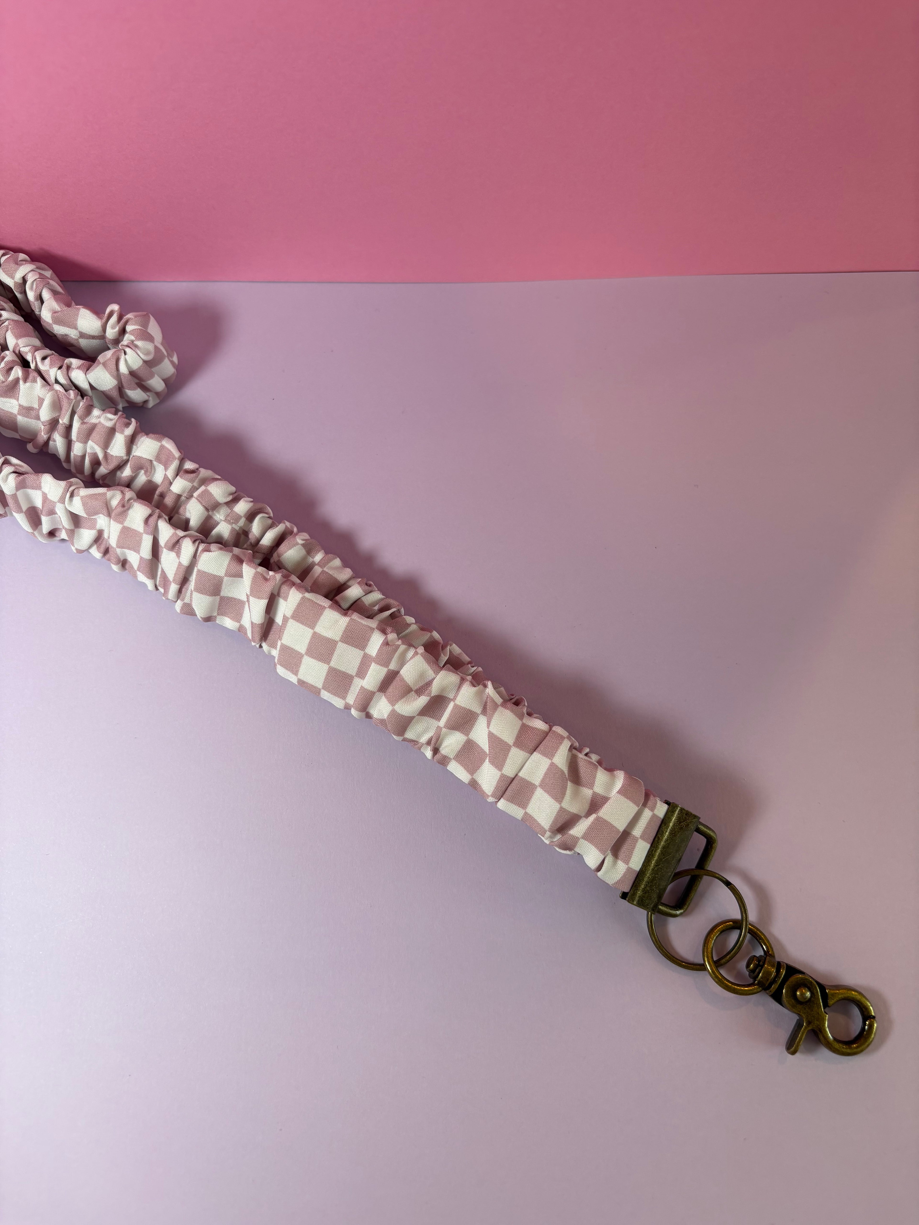 Purple and white checkered lanyard with metal clasp
