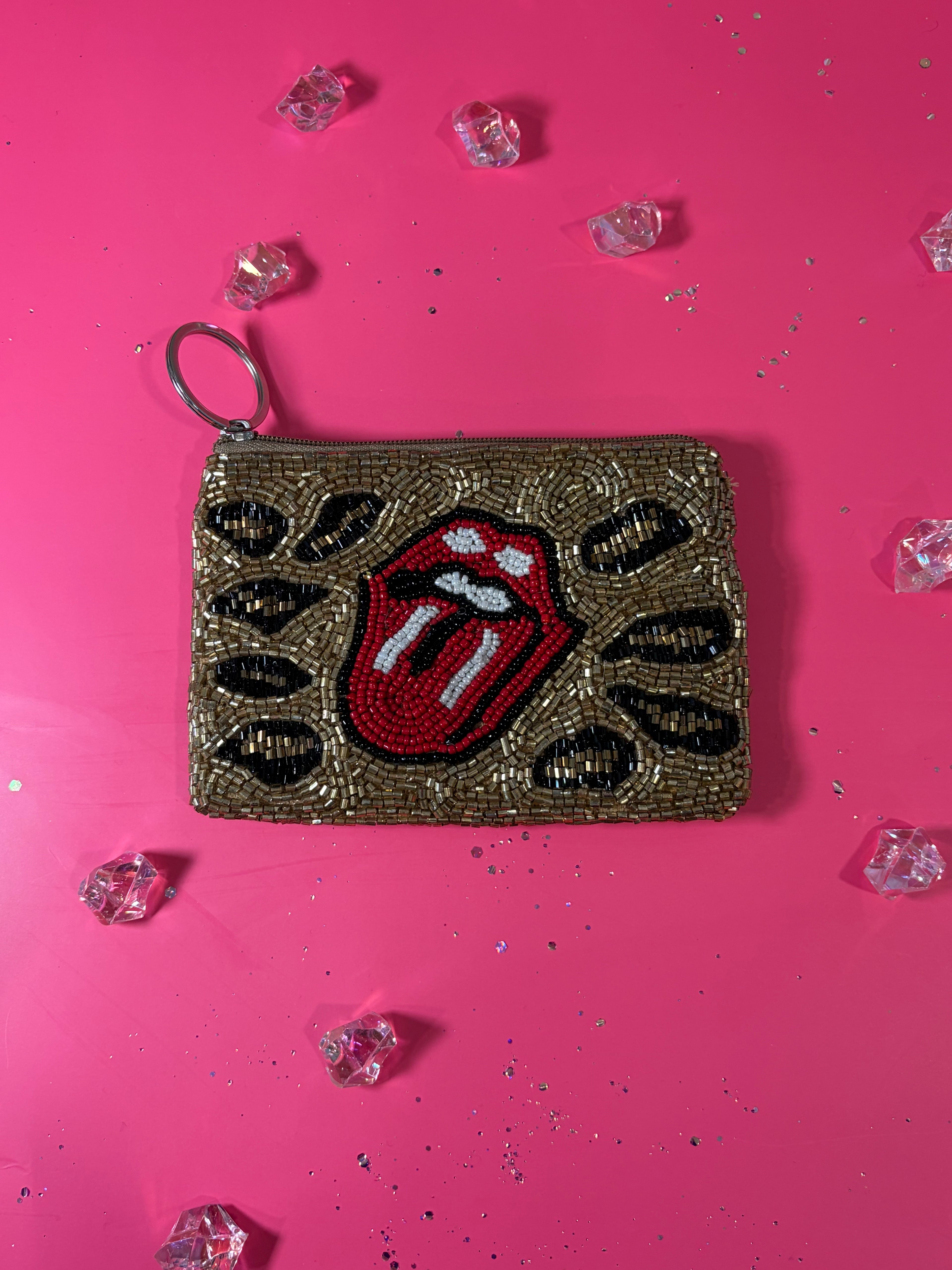 Decorative pouch with Rolling Stones logo on a pink background with crystals