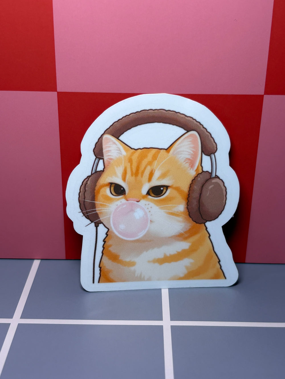 Orange cat with headphones and gum  - Sticker