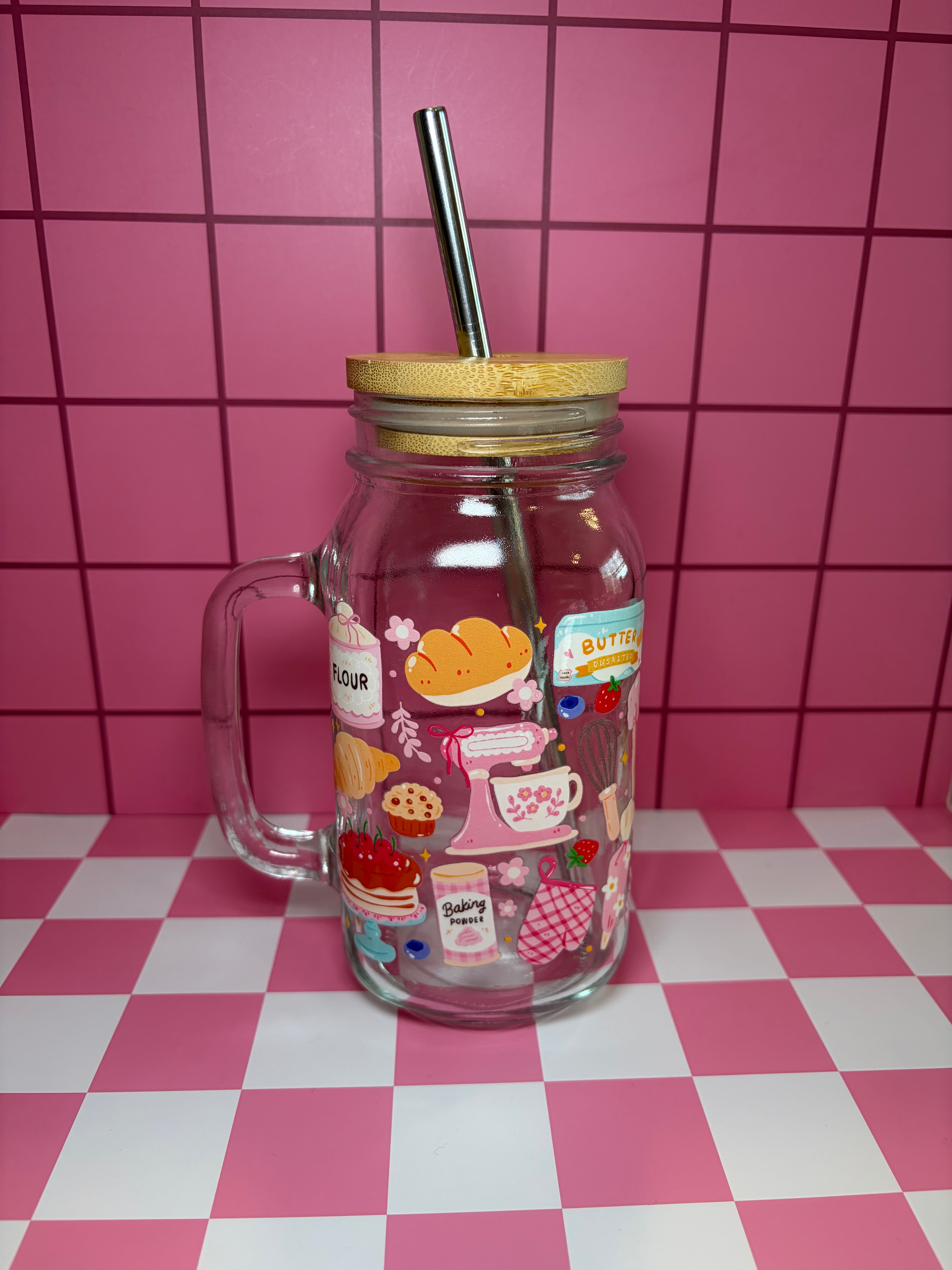 Glass jar with handle and straw lid decorated with baking icons