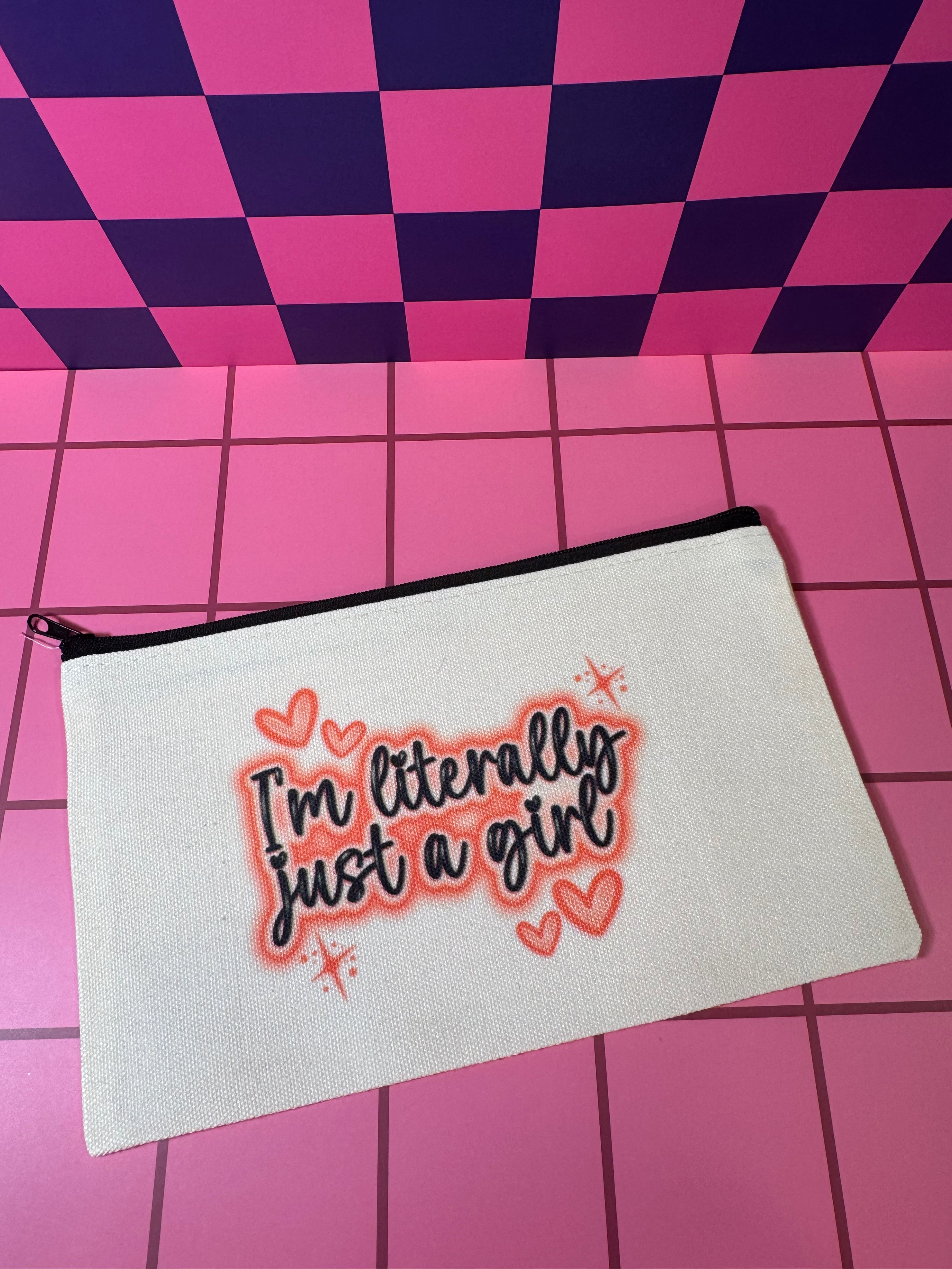 White pouch with pink 'I'm literally just a girl' text on a beige pouch